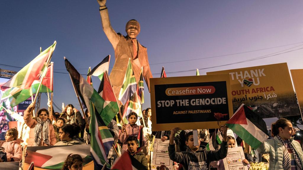Palestinians gather around a statue of Nelson Mandela after South Africa files a landmark case against Israel at the International Court of Justice, Ramallah, Jan. 10, 2024.