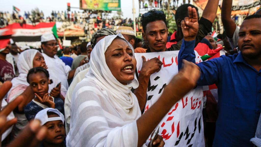 A Sudanese woman chants slogans during a demonstration demanding a civilian body to lead the transition to democracy, outside the army headquarters in Khartoum on April 12, 2019. 