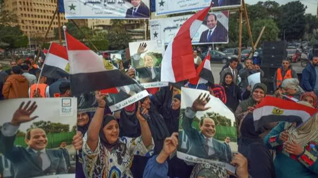 Supporters of incumbent Egyptian president Abdel-Fattah al-Sisi celebrate in Cairo after his most recent landslide electoral victory, 18 December 2023.