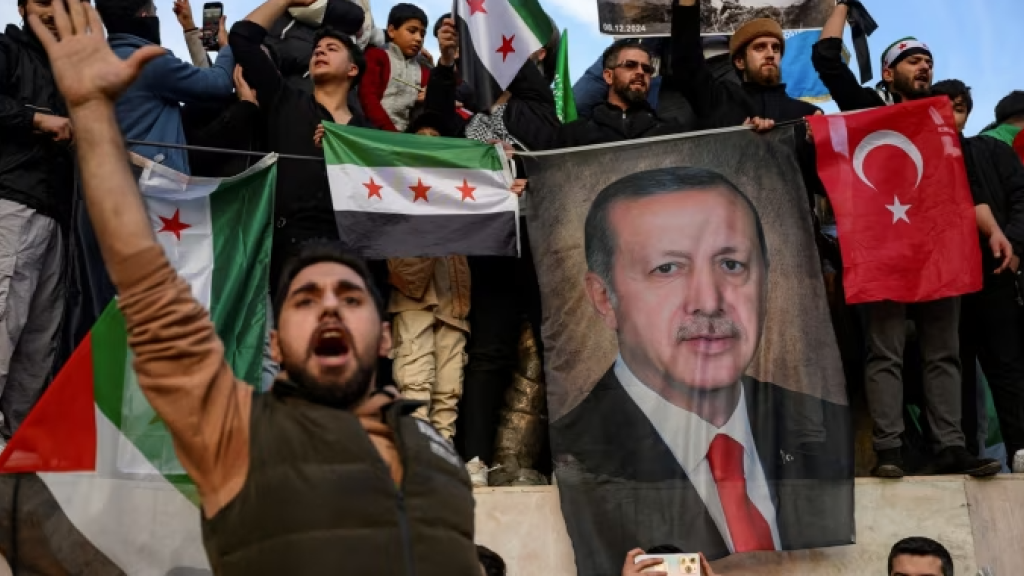 Members of the Syrian community in Istanbul hold up a banner of Turkish president Recep Tayyip Erdoğan as they celebrate the fall of Syrian president Bashar al-Assad this week 