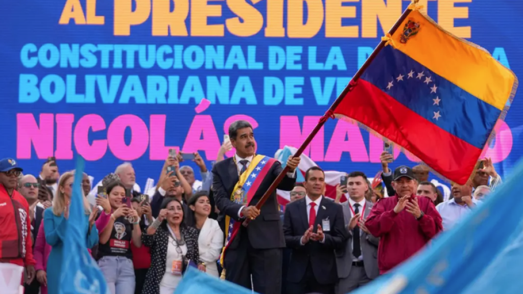 Venezuelan president Nicolas Maduro waves his nation’s flag at Miraflores Palace during his third-term inauguration in Caracas.