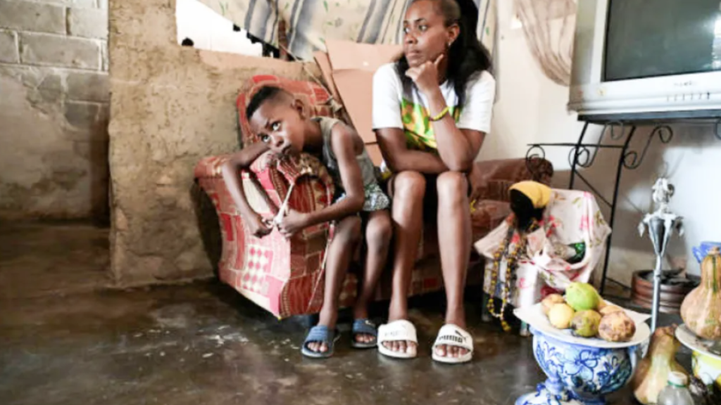 Diana Ruiz sits next to her son at their home in Havana on March 27, 2024. Shortages of food and medications, as well as long blackouts, have affected most of Cuba’s population in recent years.