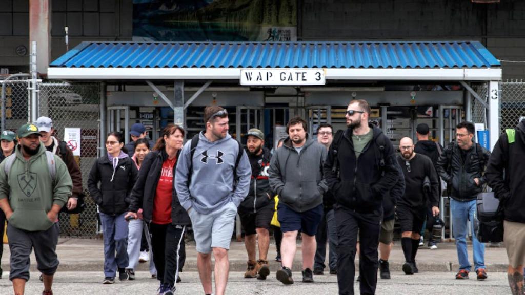 Workers leave the Stellantis Windsor Assembly Plant, in Windsor, Ont., ahead of a shutdown linked to US auto tariffs.