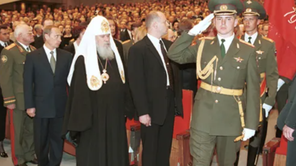 Vladimir Putin, the Russian Orthodox Patriarch and various ministers and soldiers attend a V Day memorial at the Kremlin Palace in 2000