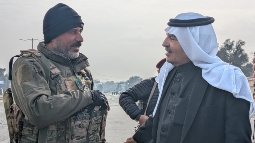 Sheikh Akram Mashoush talks to an SDF soldier in Heseke.