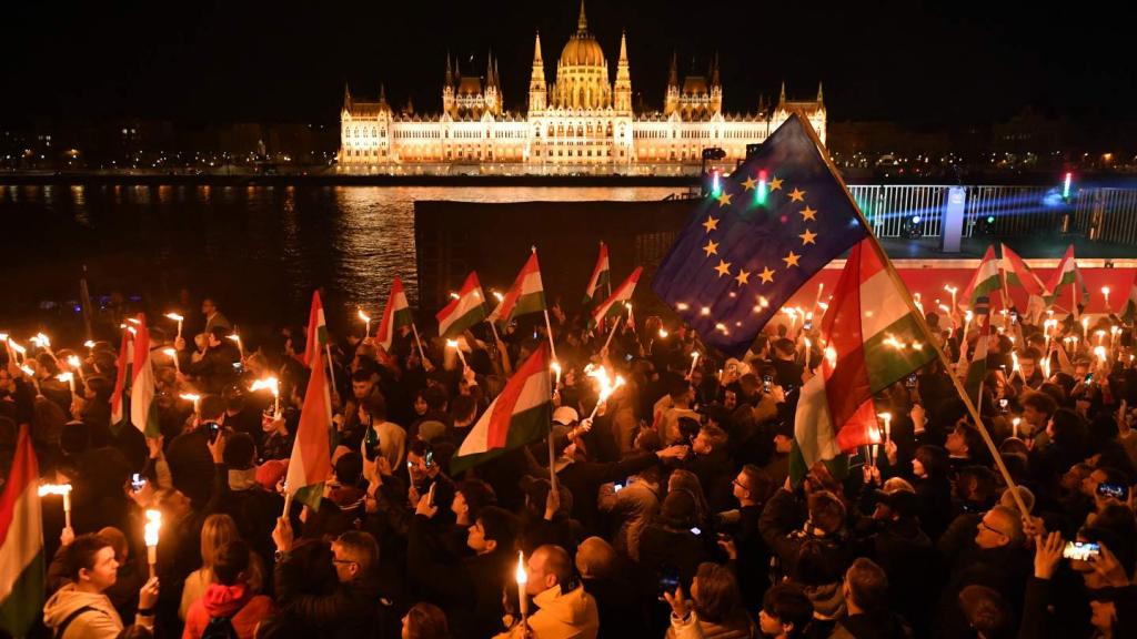Supporters of the pro-European conservative TISZA party celebrate during the election night on the banks on the river Danube with the Parliament building in the background, in Budapest after the general election in Hungary, on April 12, 2026.(Ferenc Isza / AFP via Getty Images)