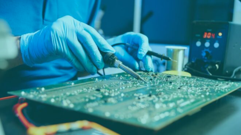 worker in the Philippines assembles electronic circuit