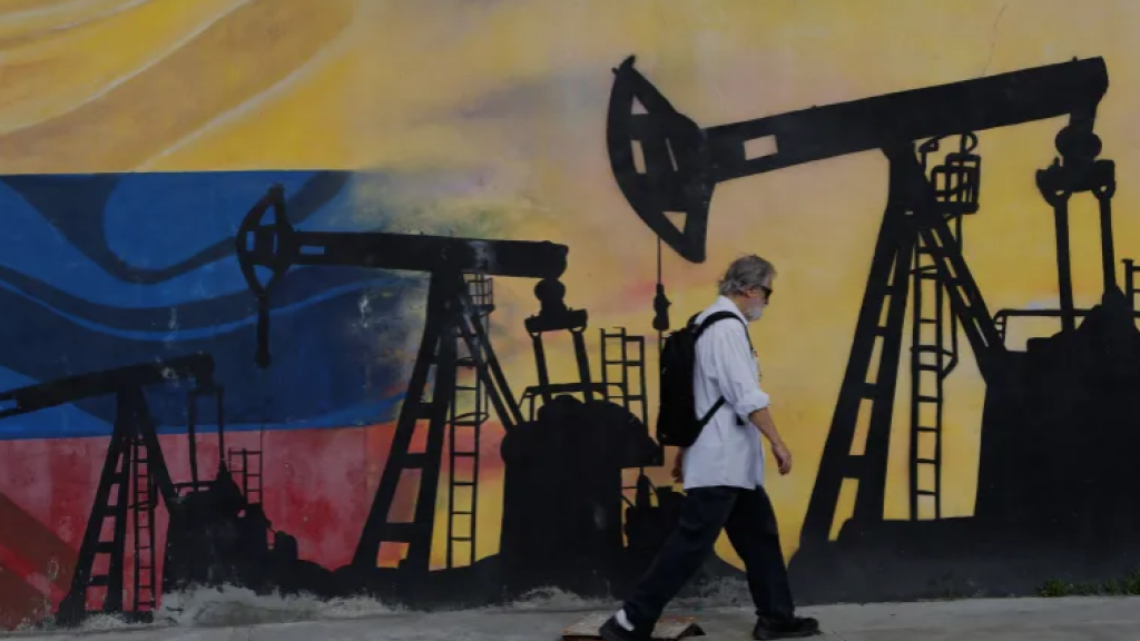 A pedestrian walks past a mural featuring oil wells in Caracas, Venezuela on August 29, 2026, a day after US President Donald Trump announced a deal giving the United States a stake in Venezuela’s oil reserves 