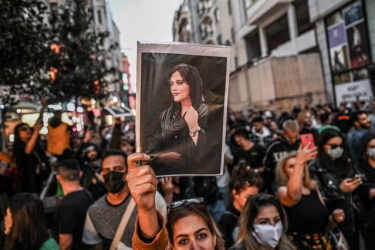 A protester holds a portrait of Mahsa Amini during a demonstration in support  of Mahsa Aminiin Tehran on September 22. 