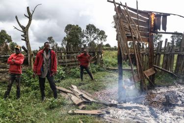 Kenyatta Ngusilo (C), a member of the Ogiek community, watches as his storehouse burns in Sasimwani Mau Forest, 2023. Hundreds of Ogiek people were left homeless after the Kenyan government evicted alleged encroachers.