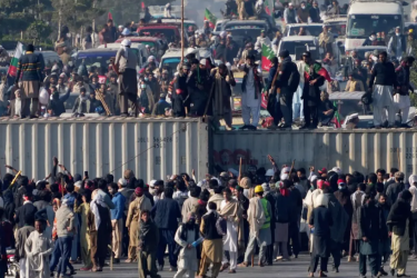 Imran Khan’s supporters broke through security barriers on roads blocked with shipping containers as they responded to his call for a sit-in protest. 