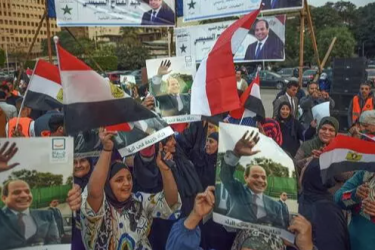 Supporters of incumbent Egyptian president Abdel-Fattah al-Sisi celebrate in Cairo after his most recent landslide electoral victory, 18 December 2023.