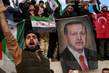 Members of the Syrian community in Istanbul hold up a banner of Turkish president Recep Tayyip Erdoğan as they celebrate the fall of Syrian president Bashar al-Assad this week 