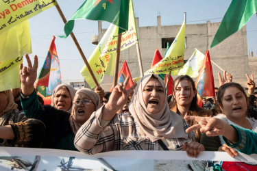 Women lead the front row, raising their voices in protest during a demonstration in Kobane on January 16, condemning Turkey’s attack on a civilian convoy near Tishrin Dam.