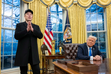 Elon Musk takes questions from reporters as President Trump looks on in the Oval Office of the White House on Tuesday.