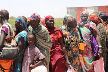 South Sudanese people queue to get on board a boat after fleeing fighting in Sudan, 8 May 2024.