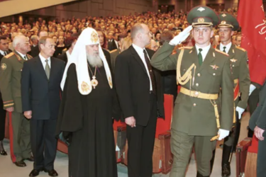 Vladimir Putin, the Russian Orthodox Patriarch and various ministers and soldiers attend a V Day memorial at the Kremlin Palace in 2000