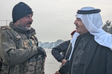 Sheikh Akram Mashoush talks to an SDF soldier in Heseke.