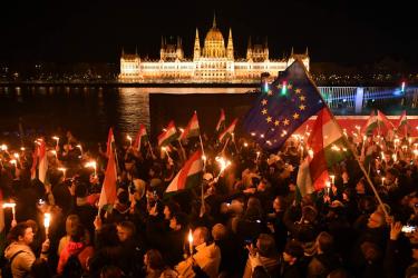 Supporters of the pro-European conservative TISZA party celebrate during the election night on the banks on the river Danube with the Parliament building in the background, in Budapest after the general election in Hungary, on April 12, 2026.(Ferenc Isza / AFP via Getty Images)