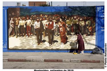 sweeper in front of mural