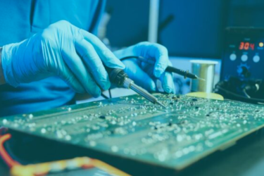 worker in the Philippines assembles electronic circuit