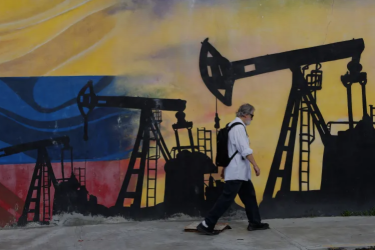 A pedestrian walks past a mural featuring oil wells in Caracas, Venezuela on August 29, 2026, a day after US President Donald Trump announced a deal giving the United States a stake in Venezuela’s oil reserves 