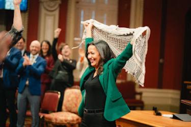 QS parliamentary leader Ruba Ghazal, of Palestinian origin, hoists a keffiyeh at the swearing-in of the party’s MNAs at Quebec's National Assembly.
