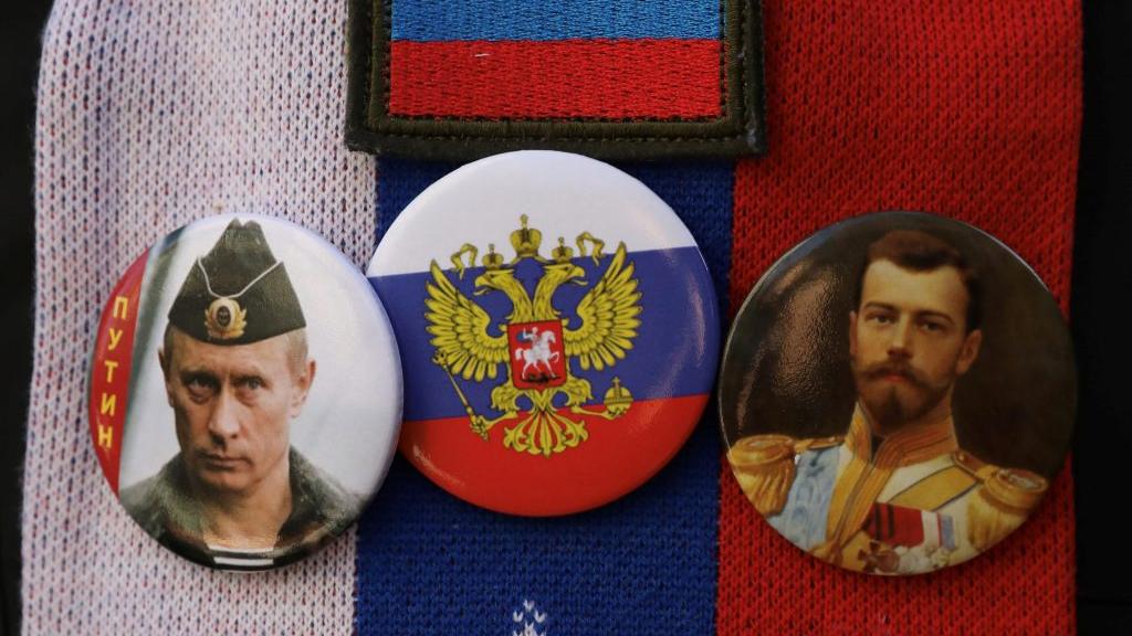 Badges of Putin and Tsar Nicholas