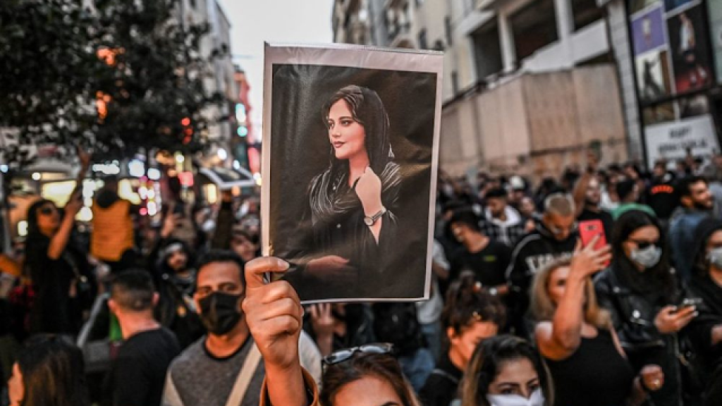 A protester holds a portrait of Mahsa Amini during a demonstration in support  of Mahsa Aminiin Tehran on September 22. 